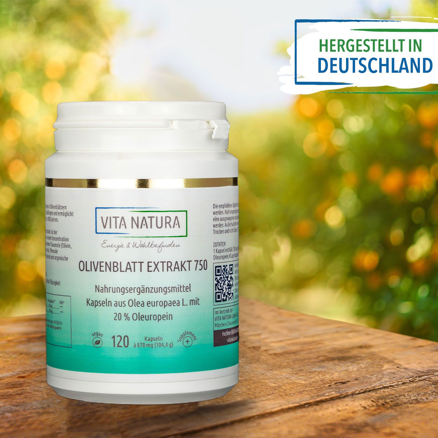 Dose mit Olivenblatt Extrakt auf einem Holztisch mit Natur im Hintergrund Dose mit Olivenblatt Extrakt auf einem Holztisch mit Natur im Hintergrund